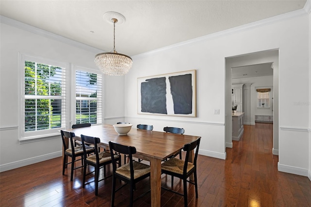 dining room with ornamental molding, a chandelier, dark wood-style floors, and baseboards