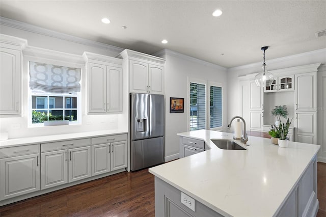kitchen with stainless steel fridge, a sink, dark wood finished floors, recessed lighting, and a kitchen island with sink