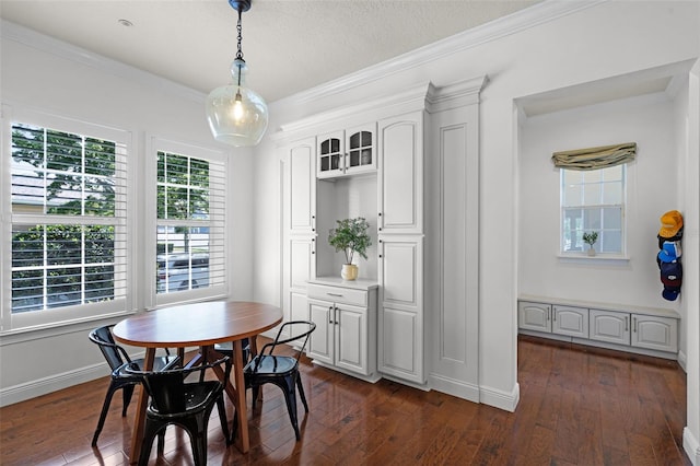 dining space featuring dark wood-style flooring, crown molding, baseboards, and a textured ceiling