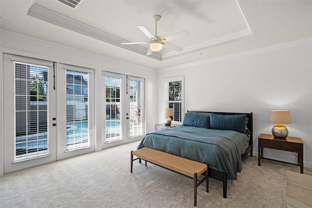 bedroom with a raised ceiling, french doors, light colored carpet, access to exterior, and crown molding