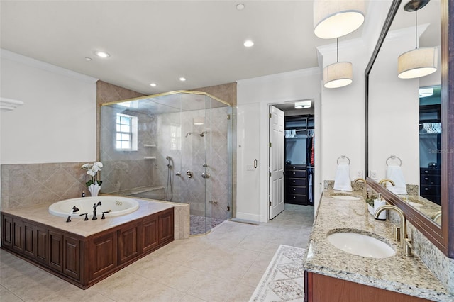 full bathroom featuring crown molding, a shower stall, a garden tub, a spacious closet, and recessed lighting
