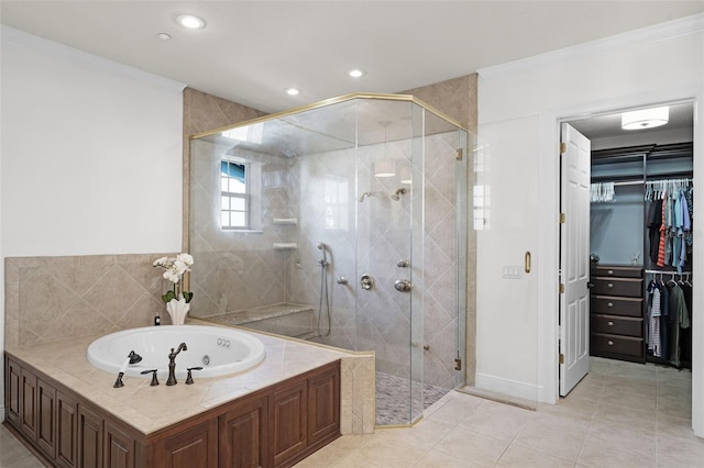 bathroom with a whirlpool tub, a shower stall, crown molding, a walk in closet, and recessed lighting