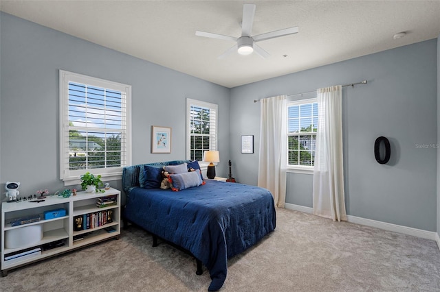 bedroom with carpet, baseboards, and ceiling fan