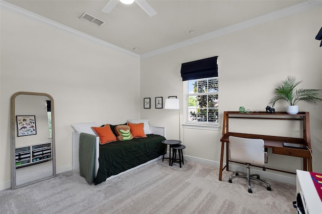 carpeted bedroom featuring ornamental molding, baseboards, and a ceiling fan