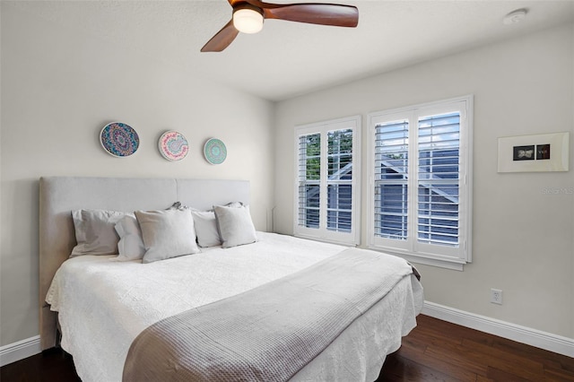 bedroom with baseboards, wood finished floors, and a ceiling fan