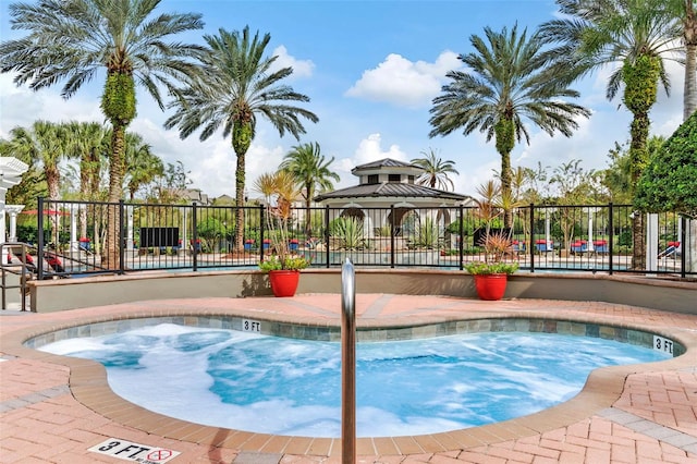view of pool with fence, a gazebo, and a swimming pool