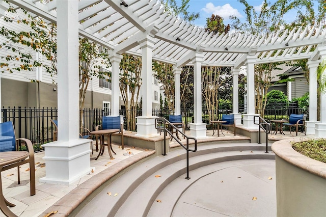 view of patio / terrace featuring a pergola and fence