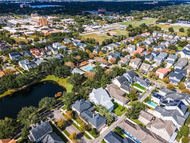 aerial view of property's location featuring a large body of water and nearby suburban area