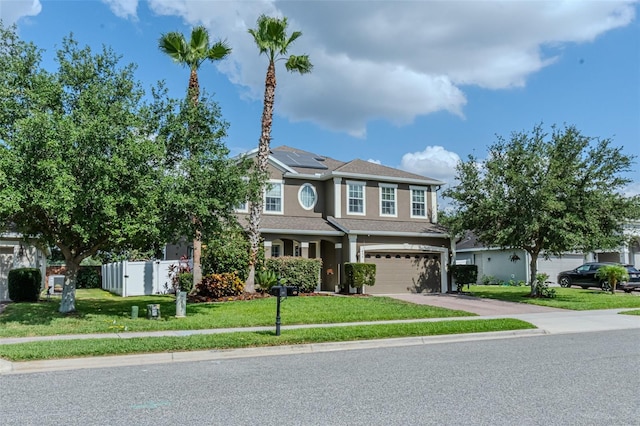 459 Millwood Pl, Winter Garden, FL 34787 - craftsman house with fence, solar panels, an attached garage, concrete driveway, and a front lawn