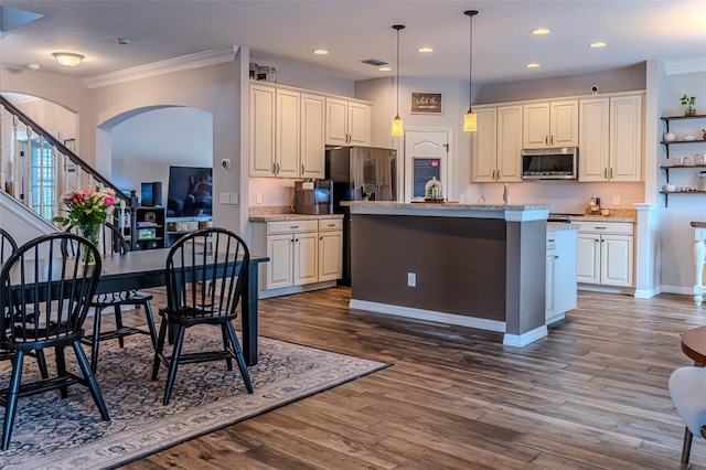 459 Millwood Pl, Winter Garden, FL 34787 - kitchen featuring crown molding, dark wood finished floors, stainless steel microwave, and arched walkways