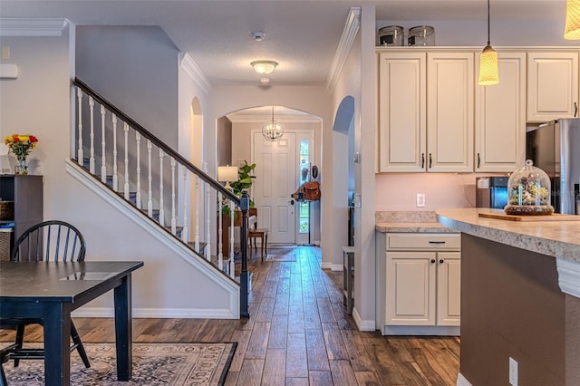459 Millwood Pl, Winter Garden, FL 34787 - kitchen featuring freestanding refrigerator, baseboards, dark wood-style flooring, arched walkways, and light countertops