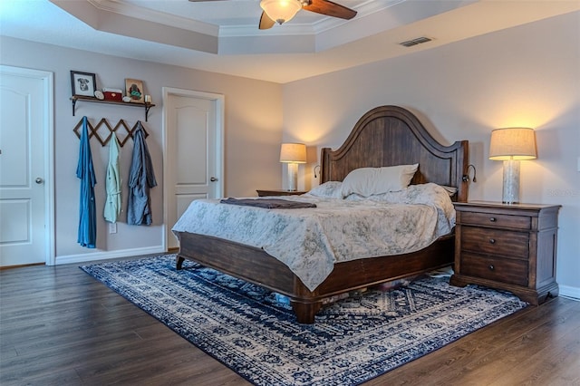 459 Millwood Pl, Winter Garden, FL 34787 - bedroom with wood finished floors, crown molding, visible vents, baseboards, and a raised ceiling