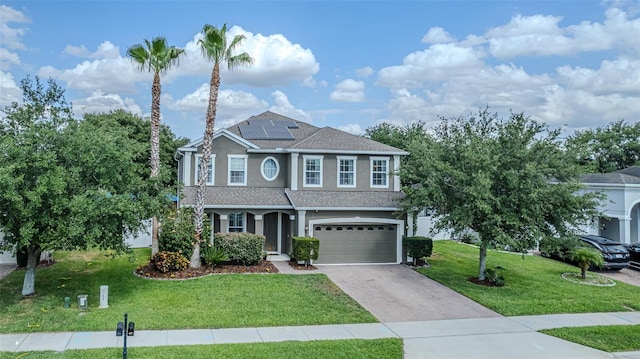 459 Millwood Pl, Winter Garden, FL 34787 - view of front of house with roof with shingles, a garage, stucco siding, a front yard, and roof mounted solar panels