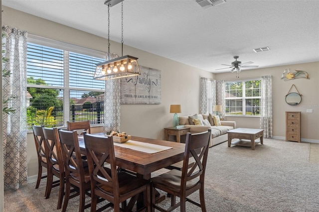 570 Cascading Creek Ln, Winter Garden, FL 34787 - dining space with carpet floors, baseboards, ceiling fan, and a textured ceiling