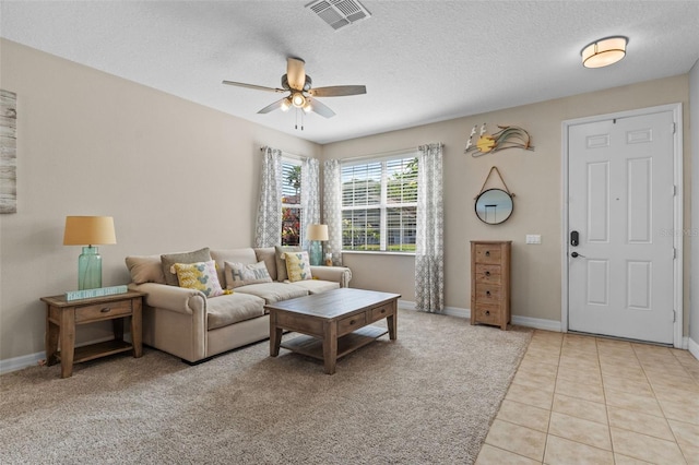 570 Cascading Creek Ln, Winter Garden, FL 34787 - living area featuring a ceiling fan, baseboards, a textured ceiling, and light tile patterned flooring