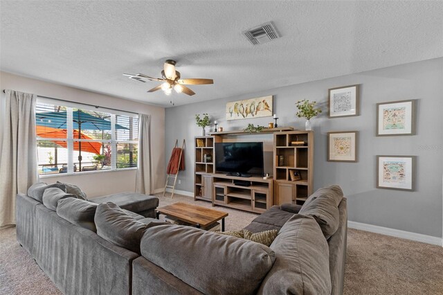 570 Cascading Creek Ln, Winter Garden, FL 34787 - living area featuring carpet, a ceiling fan, baseboards, and a textured ceiling