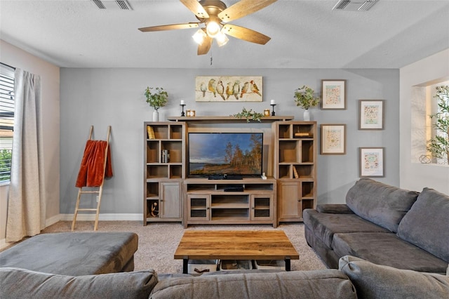 570 Cascading Creek Ln, Winter Garden, FL 34787 - carpeted living room featuring a ceiling fan, a textured ceiling, and baseboards