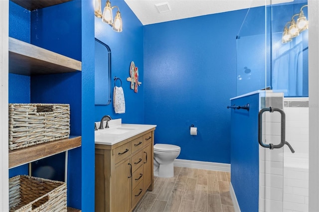570 Cascading Creek Ln, Winter Garden, FL 34787 - bathroom with a stall shower, baseboards, wood tiled floors, toilet, and vanity