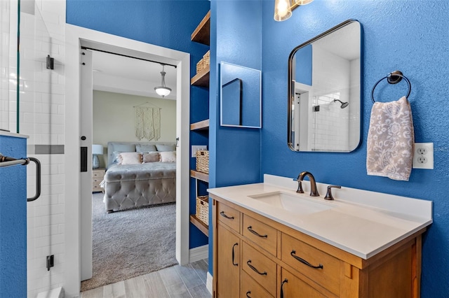 570 Cascading Creek Ln, Winter Garden, FL 34787 - bathroom featuring ensuite bath, a stall shower, wood finished floors, vanity, and a textured wall