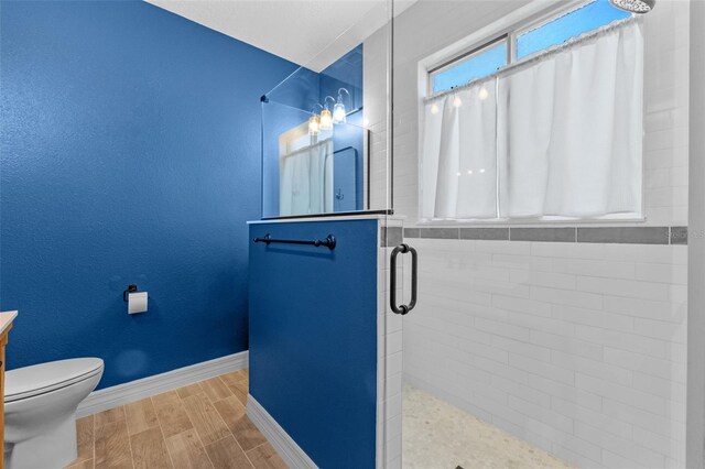 570 Cascading Creek Ln, Winter Garden, FL 34787 - full bathroom with a shower stall, wood finished floors, baseboards, toilet, and vanity