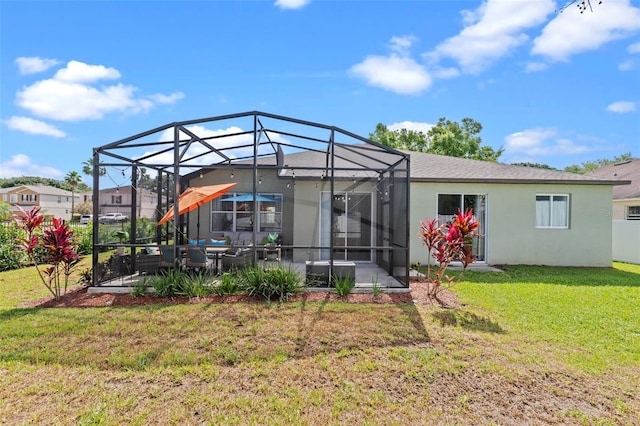 570 Cascading Creek Ln, Winter Garden, FL 34787 - back of property with stucco siding, a lawn, a patio, and glass enclosure