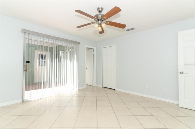 unfurnished room featuring ceiling fan and baseboards