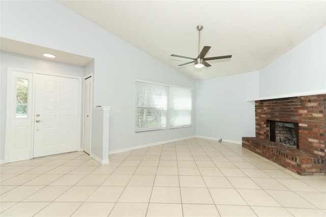 unfurnished living room featuring a ceiling fan, lofted ceiling, plenty of natural light, a brick fireplace, and baseboards