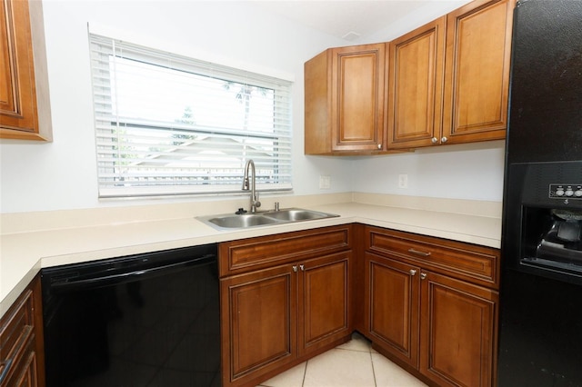 kitchen with black appliances, a sink, healthy amount of natural light, and brown cabinets