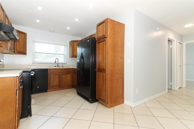 kitchen with black appliances, a sink, brown cabinets, recessed lighting, and light countertops
