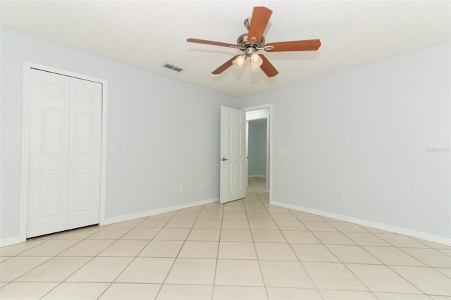 spare room featuring ceiling fan and baseboards