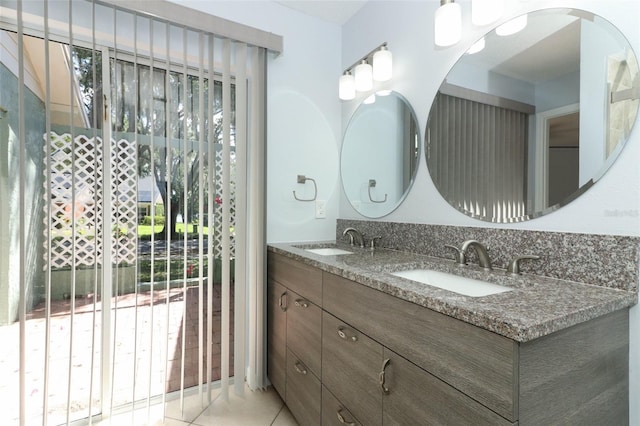 bathroom with healthy amount of natural light, double vanity, and tile patterned flooring