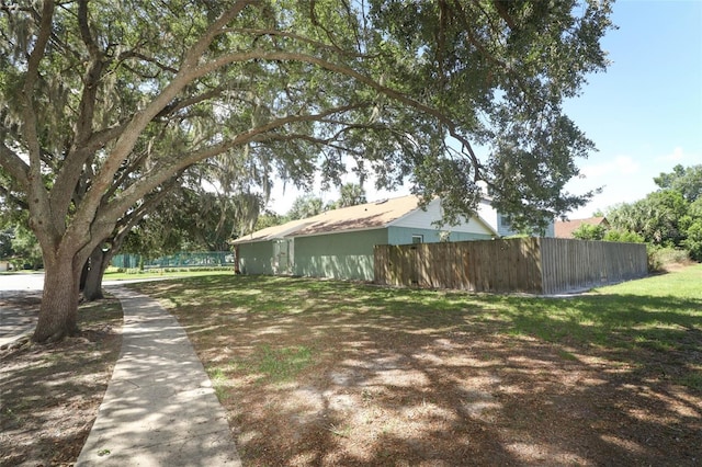 view of side of property featuring fence