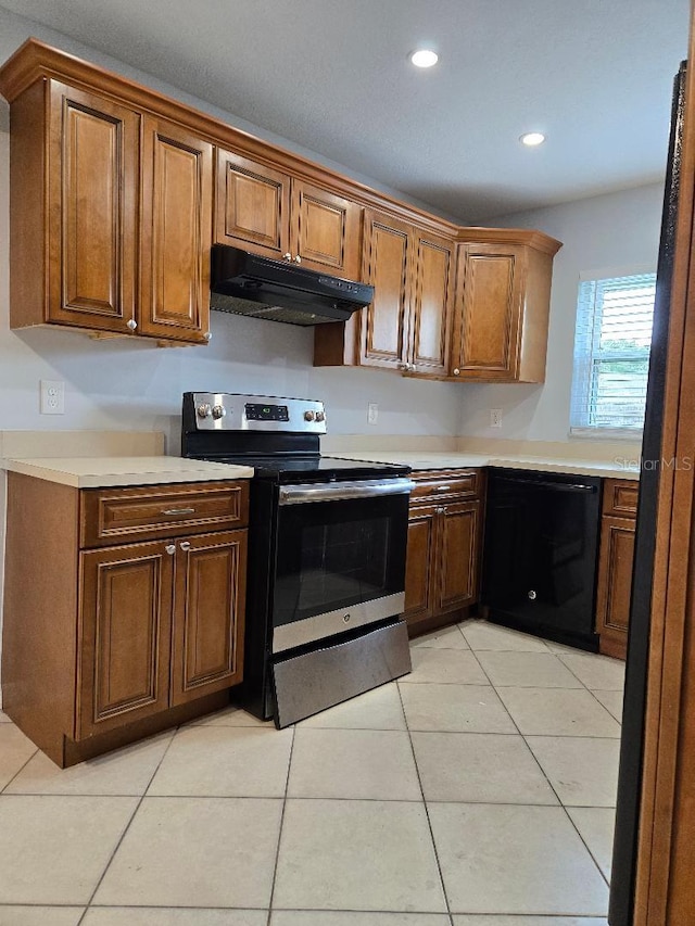 2828 Whispering Way, Winter Park, FL 32792 - kitchen with stainless steel range with electric stovetop, black dishwasher, under cabinet range hood, light countertops, and light tile patterned flooring