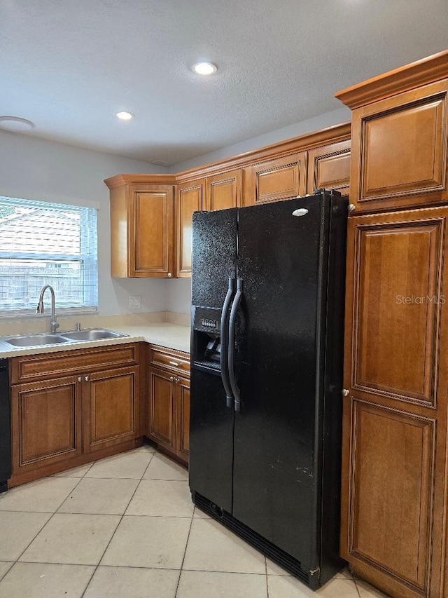 2828 Whispering Way, Winter Park, FL 32792 - kitchen with black appliances, light countertops, brown cabinetry, light tile patterned floors, and recessed lighting