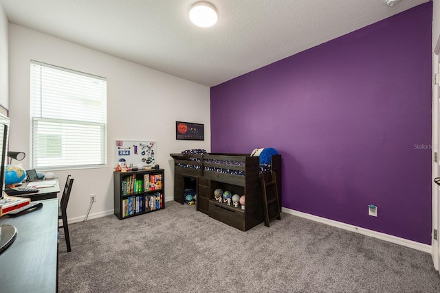 bedroom featuring carpet and baseboards