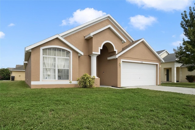 view of front of property with stucco siding, an attached garage, and a front lawn