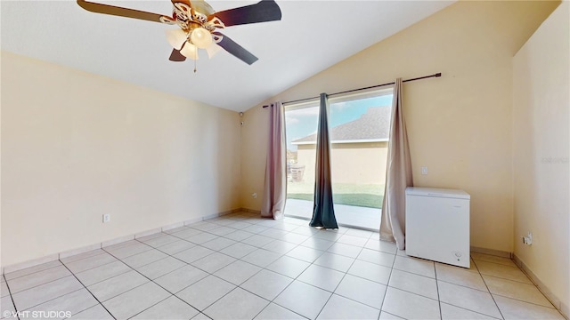 unfurnished room featuring lofted ceiling, a ceiling fan, and light tile patterned floors