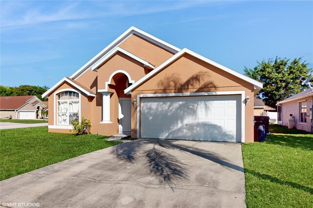 2108 Shannon Lakes Blvd, Kissimmee, FL 34743 - ranch-style home with concrete driveway, stucco siding, a front lawn, and a garage