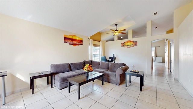 2108 Shannon Lakes Blvd, Kissimmee, FL 34743 - living area featuring arched walkways, a ceiling fan, light tile patterned floors, lofted ceiling, and baseboards