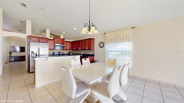 2108 Shannon Lakes Blvd, Kissimmee, FL 34743 - dining room with light tile patterned flooring, a chandelier, vaulted ceiling, recessed lighting, and arched walkways