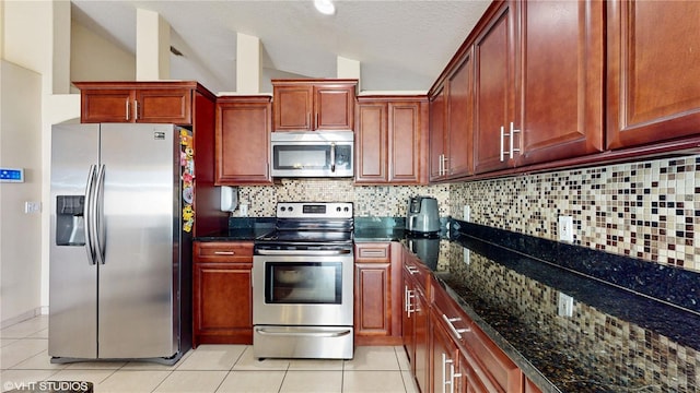 2108 Shannon Lakes Blvd, Kissimmee, FL 34743 - kitchen featuring stainless steel appliances, light tile patterned flooring, dark stone countertops, decorative backsplash, and vaulted ceiling