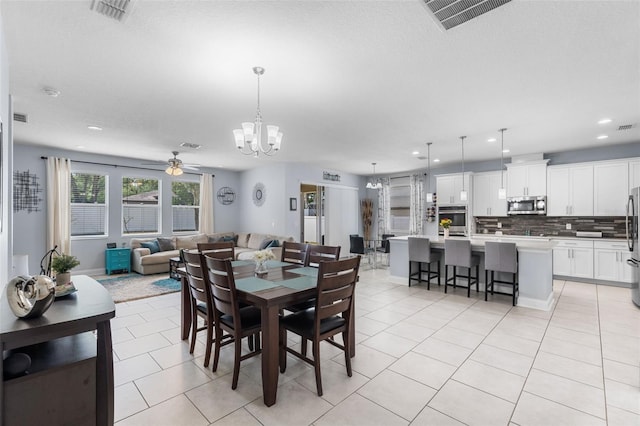 dining space with a chandelier, ceiling fan, light tile patterned floors, and recessed lighting