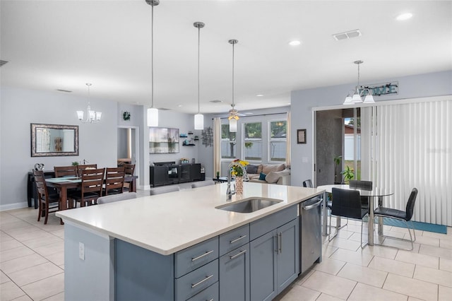kitchen with a sink, a chandelier, dishwasher, open floor plan, and light countertops
