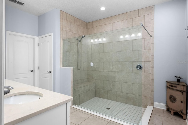 full bath with tile patterned flooring, a walk in shower, vanity, baseboards, and recessed lighting
