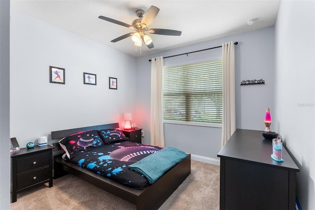bedroom featuring light carpet, ceiling fan, and baseboards