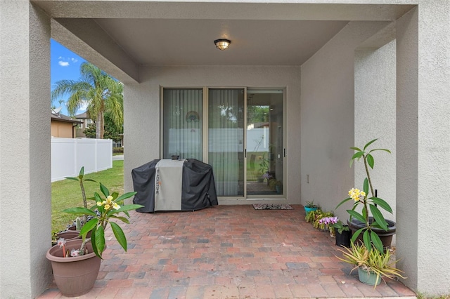 view of patio with area for grilling and fence