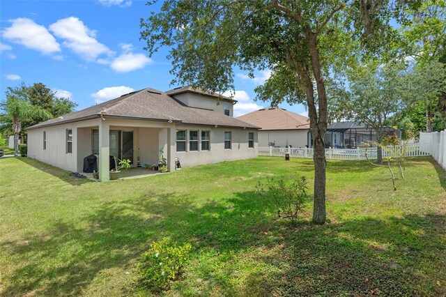 back of property with stucco siding, a patio area, and a shingled roof