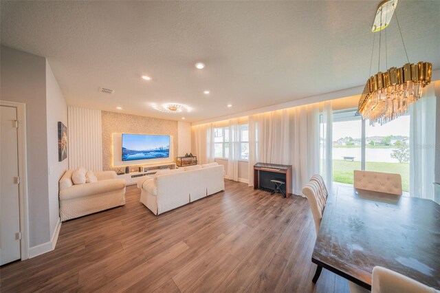 1631 Pontiff Pl, Davenport, FL 33896 - living area featuring wood finished floors, baseboards, recessed lighting, wallpapered walls, and a chandelier