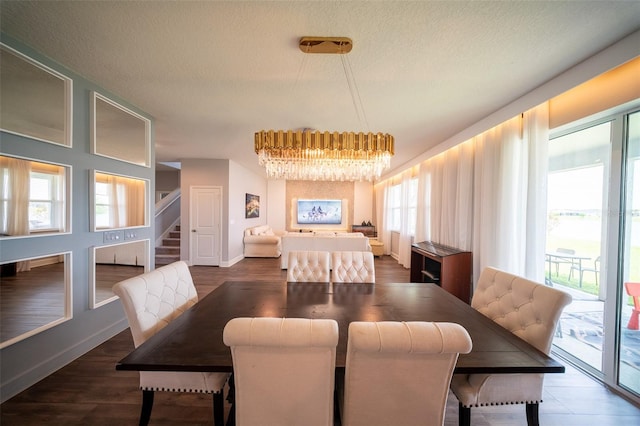 1631 Pontiff Pl, Davenport, FL 33896 - dining room featuring a chandelier, stairs, a textured ceiling, wood finished floors, and baseboards