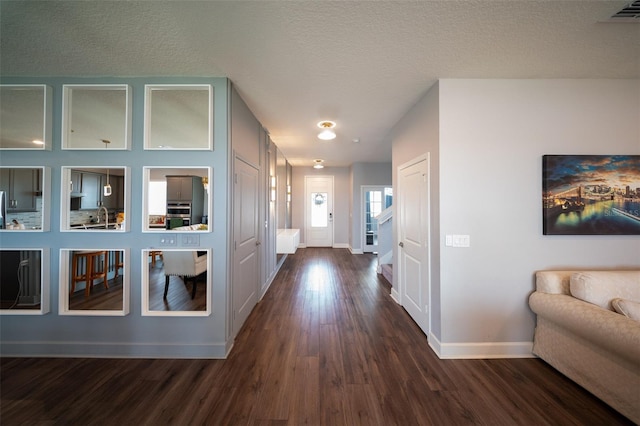1631 Pontiff Pl, Davenport, FL 33896 - hall featuring baseboards, dark wood-style flooring, and a textured ceiling